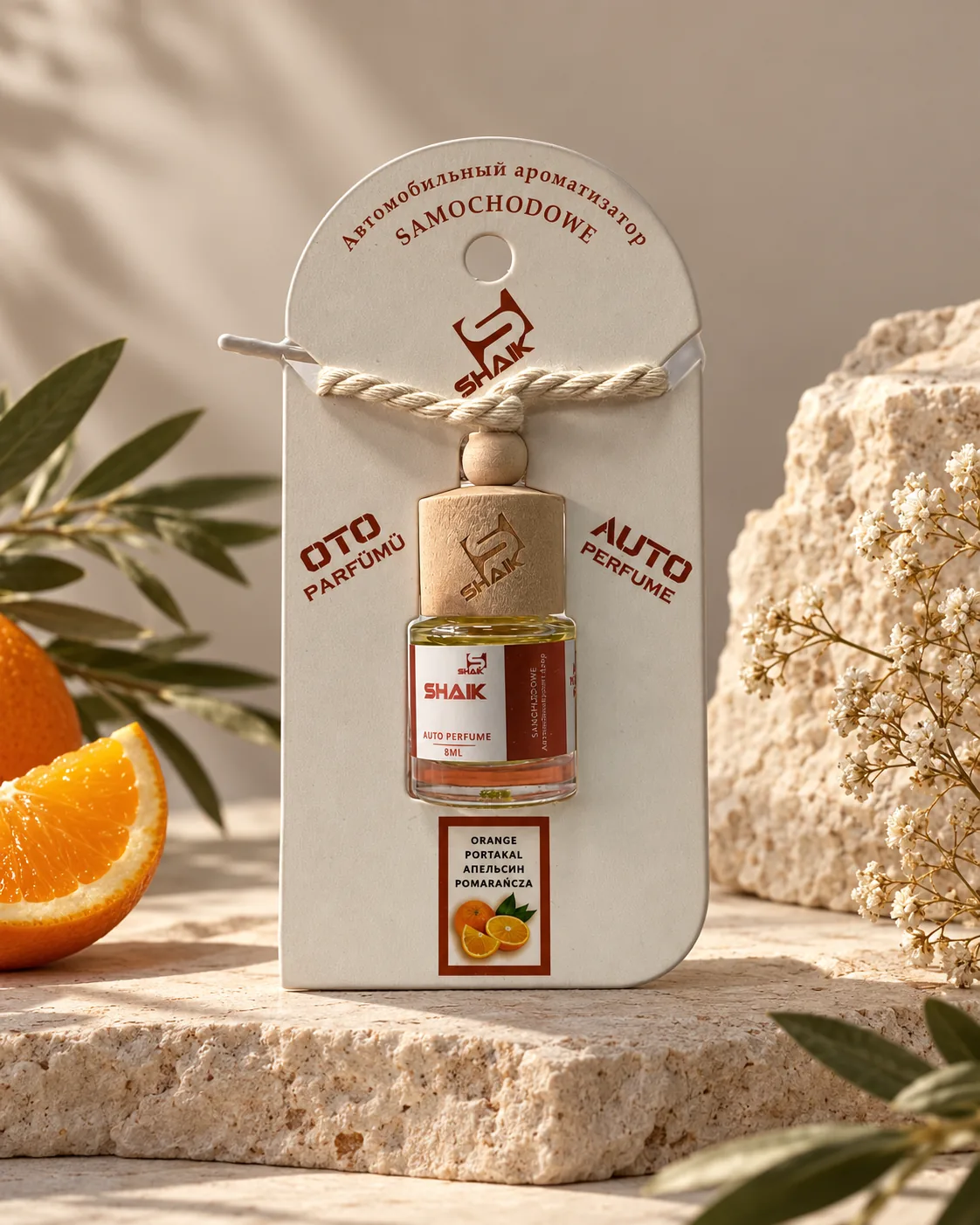 Shaik Orange Car Diffuser on a stone display