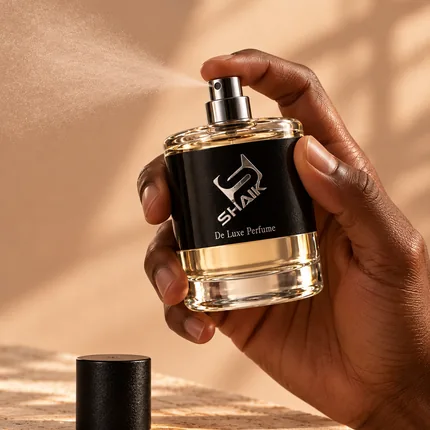 Hand spraying a Shaik men's perfume with black label