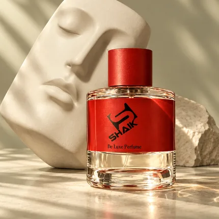 Shaik unisex perfume with red cap and label beside a sculpted face relief