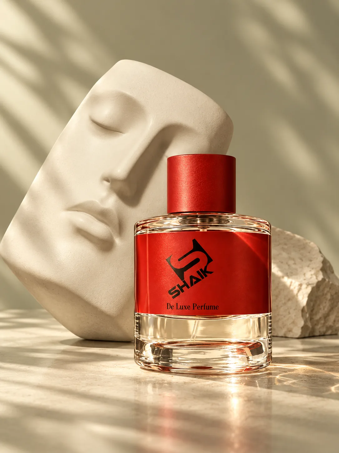 Shaik unisex perfume with red cap and label beside a sculpted face relief