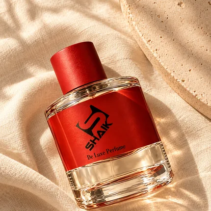 Shaik unisex perfume with red cap and label on linen