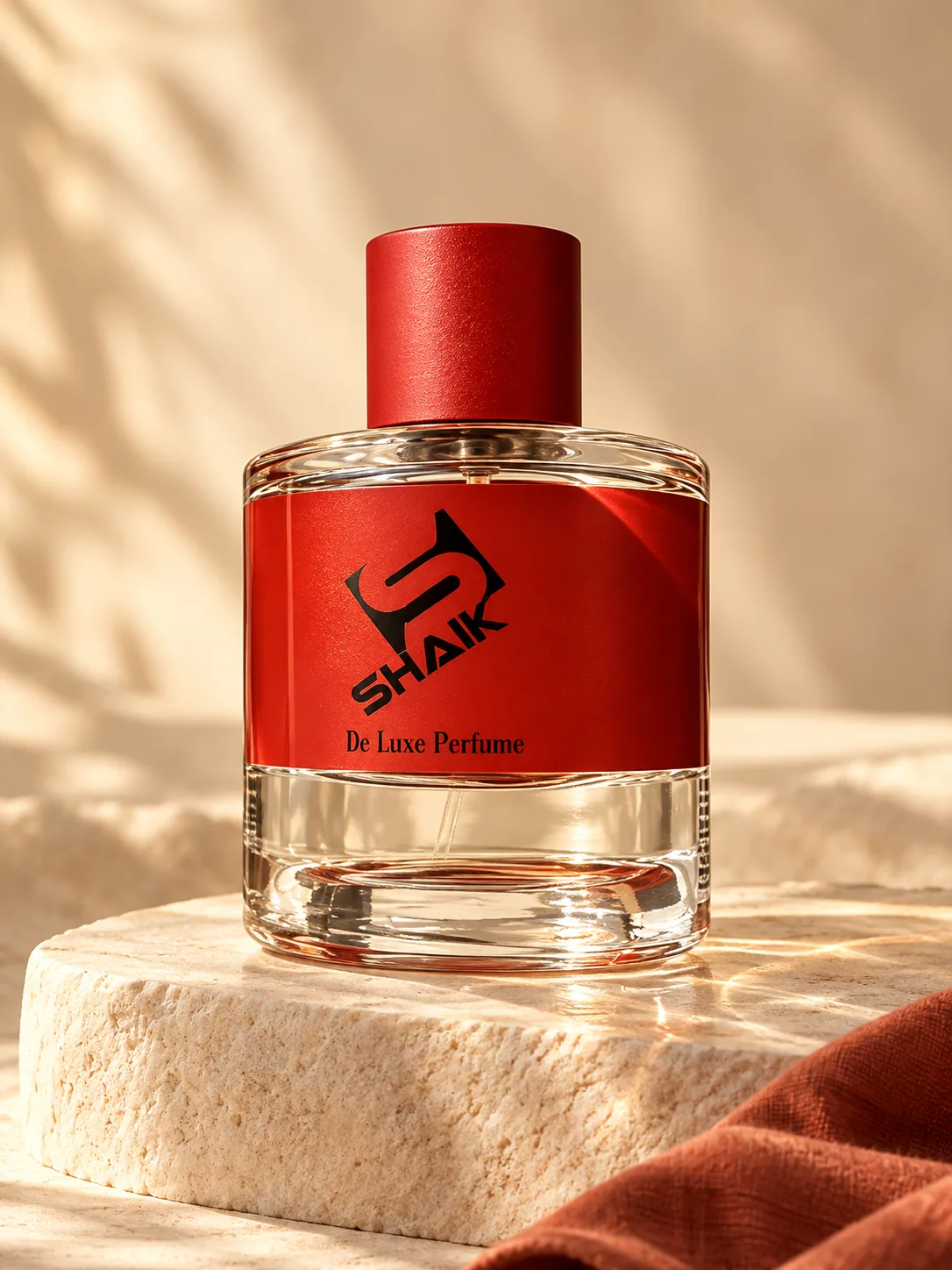 Shaik unisex perfume with red cap and label on a stone plinth