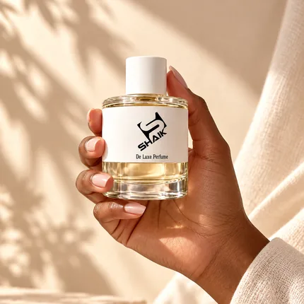 Hand holding a Shaik women's perfume with white cap and label