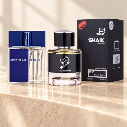 Shaik M 03 bottle and box beside Armand Basi In Blue, the fragrance that inspired it