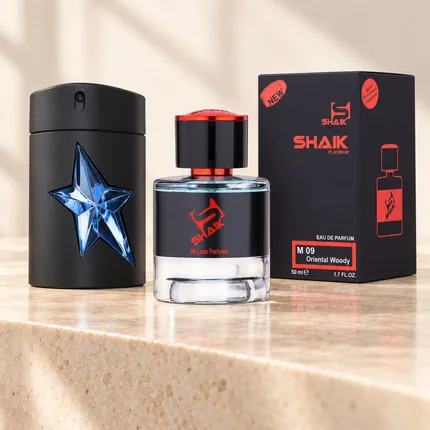 Shaik M 09 bottle and box beside Mugler A*Men, the fragrance that inspired it