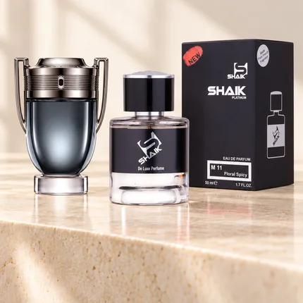 Shaik M 11 bottle and box beside Paco Rabanne Invictus Intense, the fragrance that inspired it